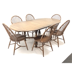  Ercol Golden Dawn finish elm extending oval dining table, turned supports joined by an 'X' stretcher (W215cm, H75cm, D108cm) and set six hoop back chairs (W50cm)  