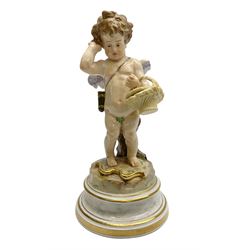 Late 19th/early 20th century Meissen figure of cupid, modelled standing with empty quiver across back, holding a basket in one arm, the other raised to head, upon a naturalistically modelled base detailed with gilt bow,  and marble effect socle base with gilt bands, with blue crossed swords mark beneath, H18.5cm