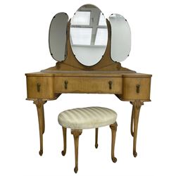 Early to mid-20th century maple eight-piece bedroom suite, decorated with floral urn and trailing linen motifs - triple wardrobe enclosed by three shaped doors, the right-hand side fitted with mirror and slides (W188cm, H195cm, D54cm); dressing table with raised triple mirror back over shaped top, fitted with three drawers, on cabriole supports (W115cm, H153cm, D53cm); oval upholstered dressing table stool on cabriole supports (55cm x 40cm, H44cm); tallboy chest fitted with double cupboard over three drawers (W82cm, H120cm, D53cm); bedside with drop leaf top over single cupboard (W42cm, H69cm, D35cm), pair of bedroom chairs (W45cm, H90cm), 4' 6'' double head and footboards