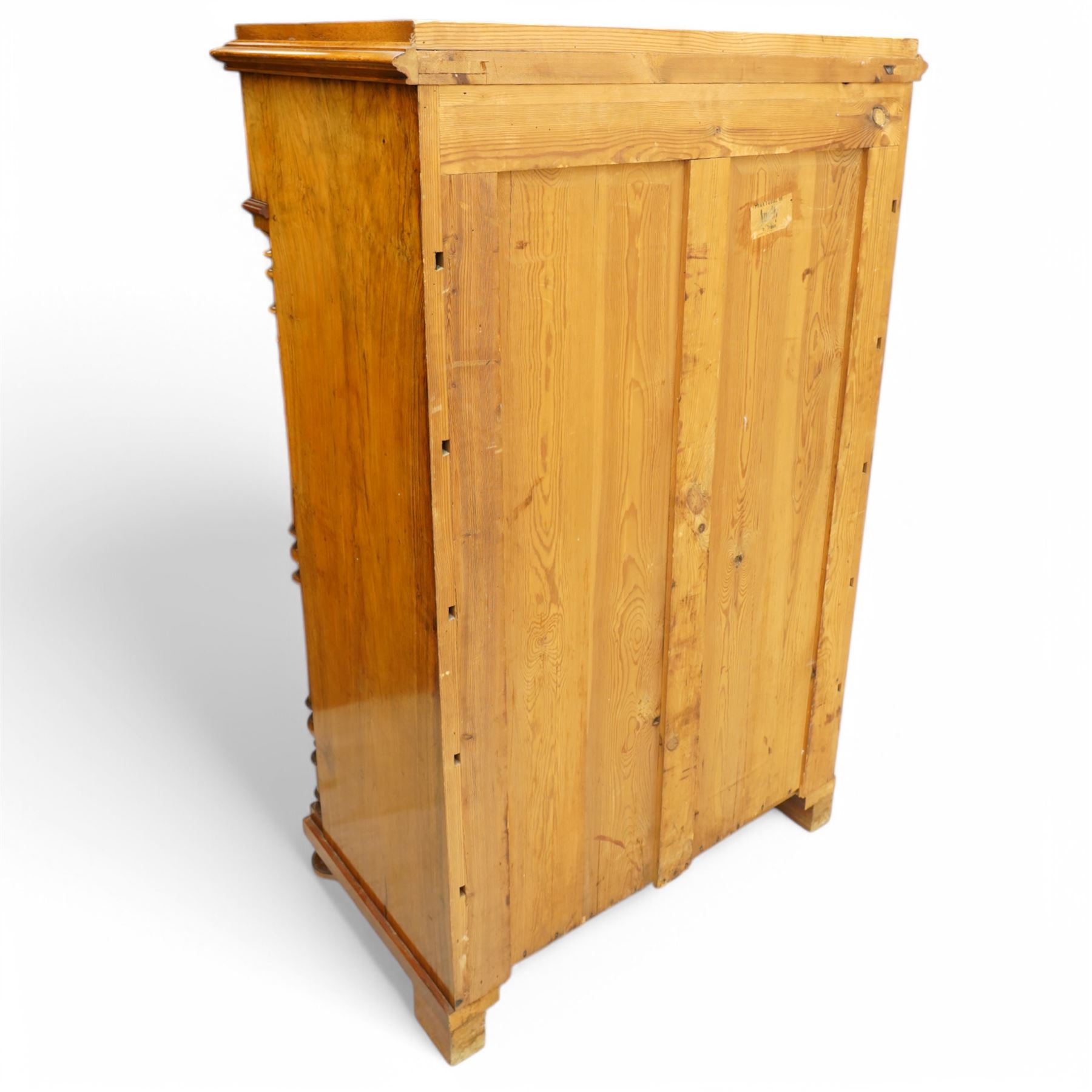 Tall late 19th century walnut chest, stepped and moulded top over six drawers, ornate cast gilt metal handles, enclosed by turned and fluted upright columns, on turned front feet 