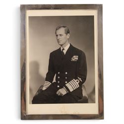 HRH The Duke of Edinburgh signed black and white presentation portrait photograph of Prince Philip wearing Naval uniform, signed in ink on mount ‘Philip 1959’, 20cm x 15cm, contained within a rectangular silver frame, together with a framed photograph of the Prince in India 1959 greeting guests at a formal event and a further black and white photograph