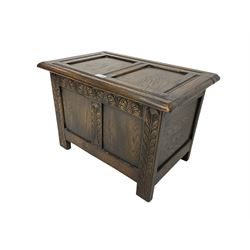 Small 20th century oak blanket box, panelled form, hinged lid, the front carved with foliate design