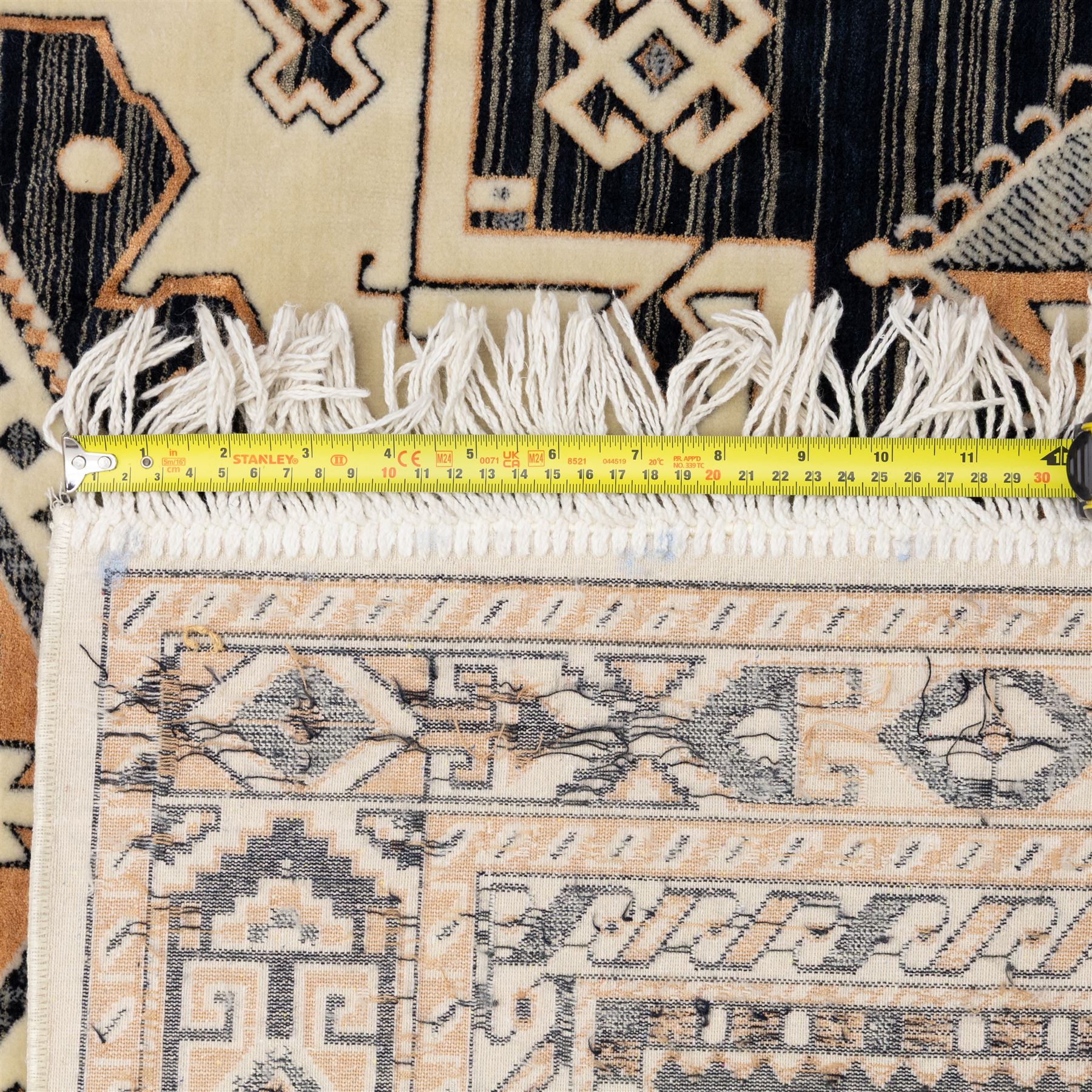 Two rugs, small Bokhara-type rug, terracotta ground with repeating hooked lozenge medallions enclosed by geometric borders (H 120cm, W 83cm); and a cream-ground rug, central lozenge medallion with geometric spandrels and border motifs (H 145cm, W 101cm),