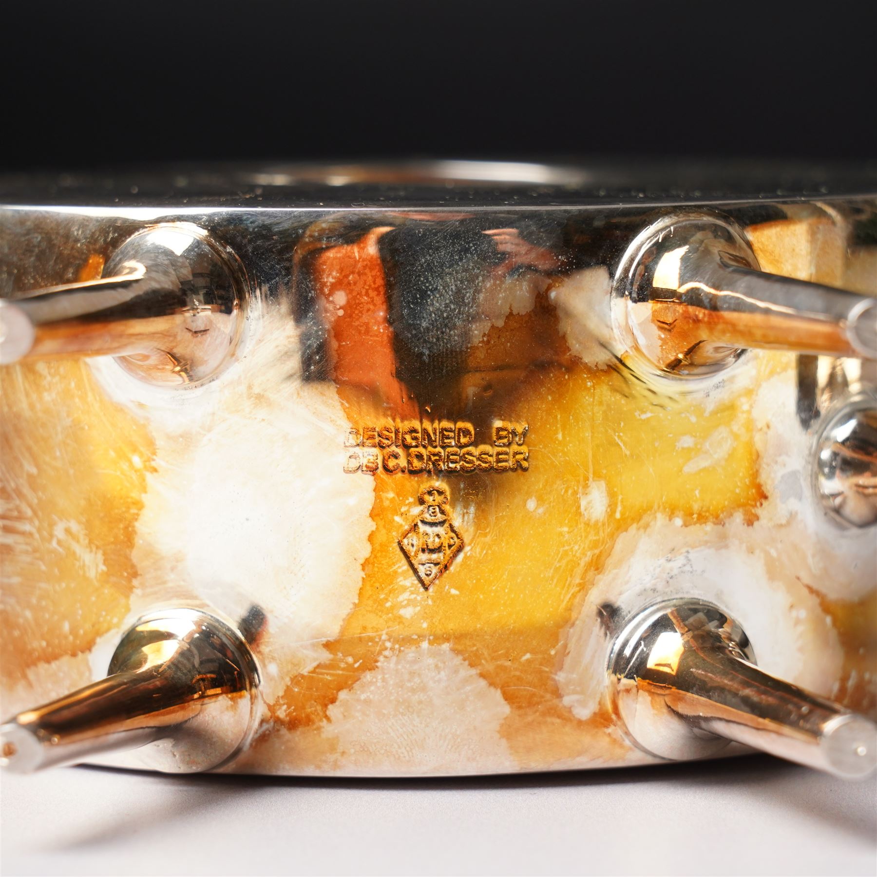 Manner of Christopher Dresser (1834-1904) - two art deco design silver plated teapots, of circular and square form with vacant centre, ebonised handles, each marked and with registration mark, max H18cm (2)