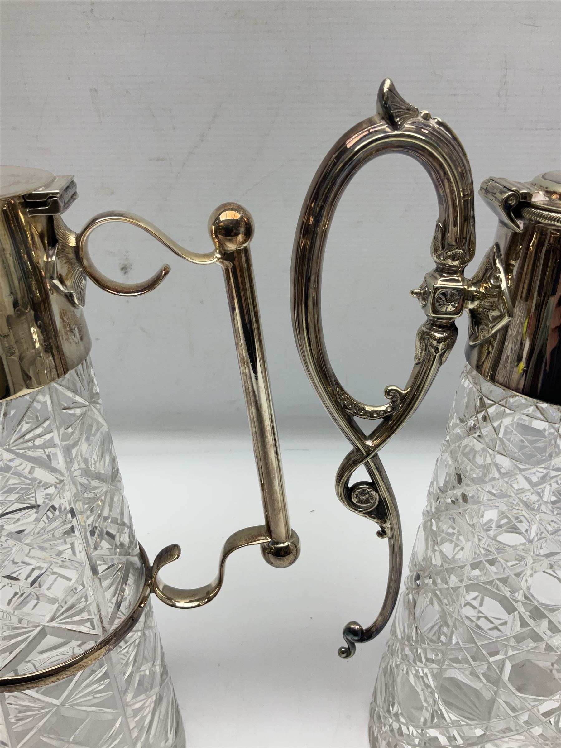 Pair of Mappin and Webb silver plate pierced pedestal bon bon dishes, together with other silver plate comprising teapot stand engraved with lion's head to centre, two cut glass claret jugs, two bottle coasters with acorn decoration, two open salts upon dolphin mounts, tea caddy, three piece cruet set and a large oval tray with pierced sides and upon four ball feet