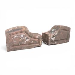 Pair of 19th century hewn and carved stone wall ends, the facias carved as shaped faux fie...