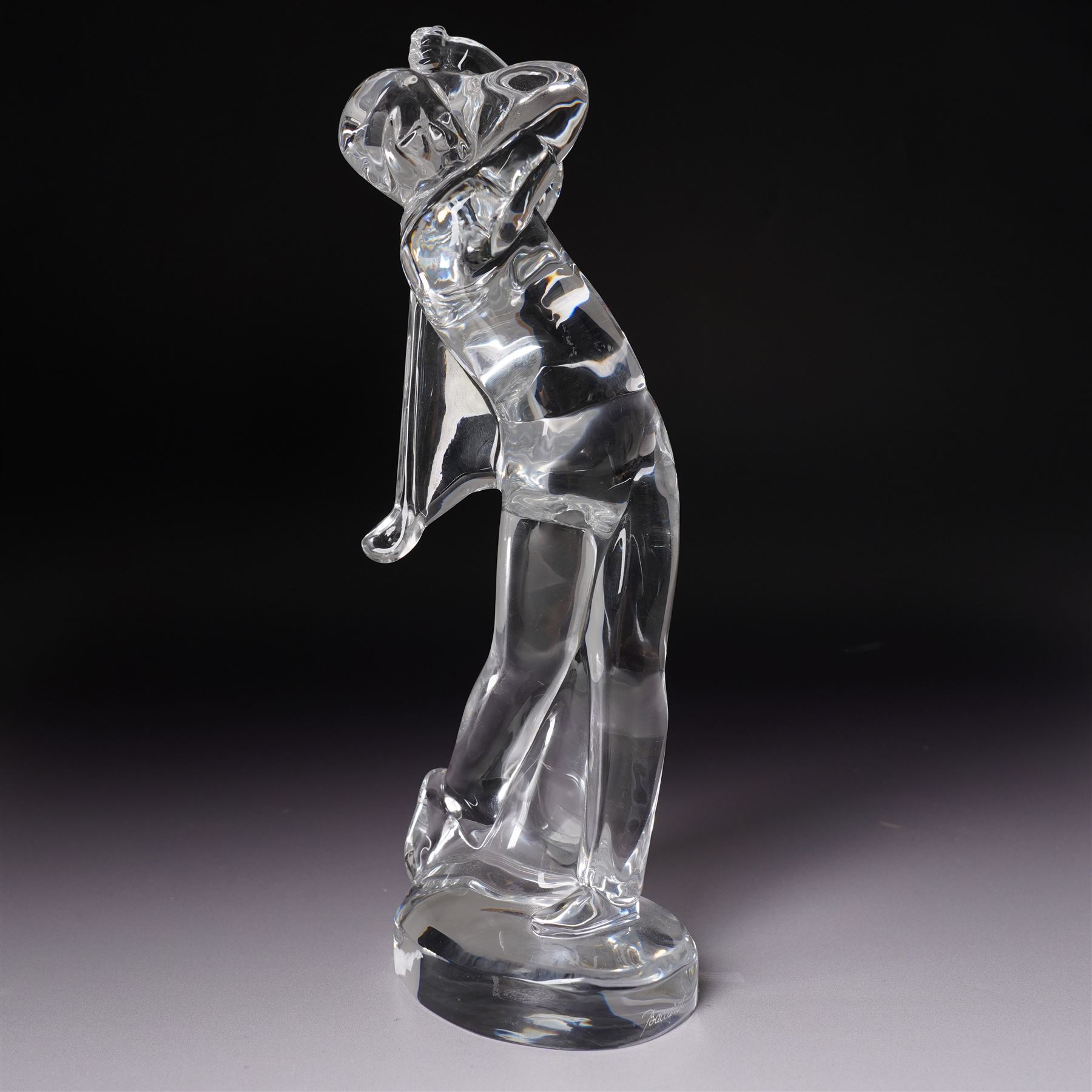 Baccarat figurine of a golfer, depicting a golfer in mid-swing, together with Nachtmann bird, golfer H24cm