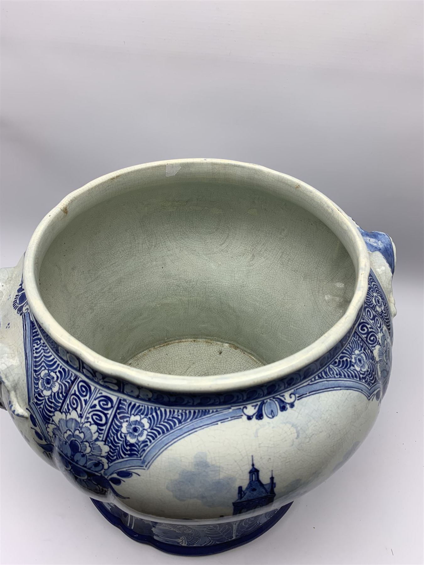 Large 20th century Delft blue and white jardinière, of baluster form with twin zoomorphic mask lug handles, decorated with hand painted panels of waterside scenes, within foliate surround, impressed and painted marks beneath for De Porceleyne Fles workshop, Delft, H35cm, rim D32