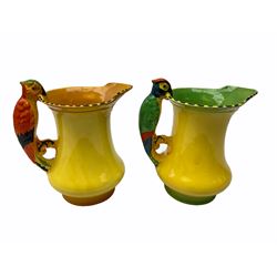 Two Burleigh Ware 1930's Parrot jugs, hand painted with butterfly design upon a yellow ground, with handles in the form of parrots, H19cm, together with a Lladro figure Pretty Pickings, model no 5222, H18.5cm, a group of 20th century Belleek vases and dishes, etc. 