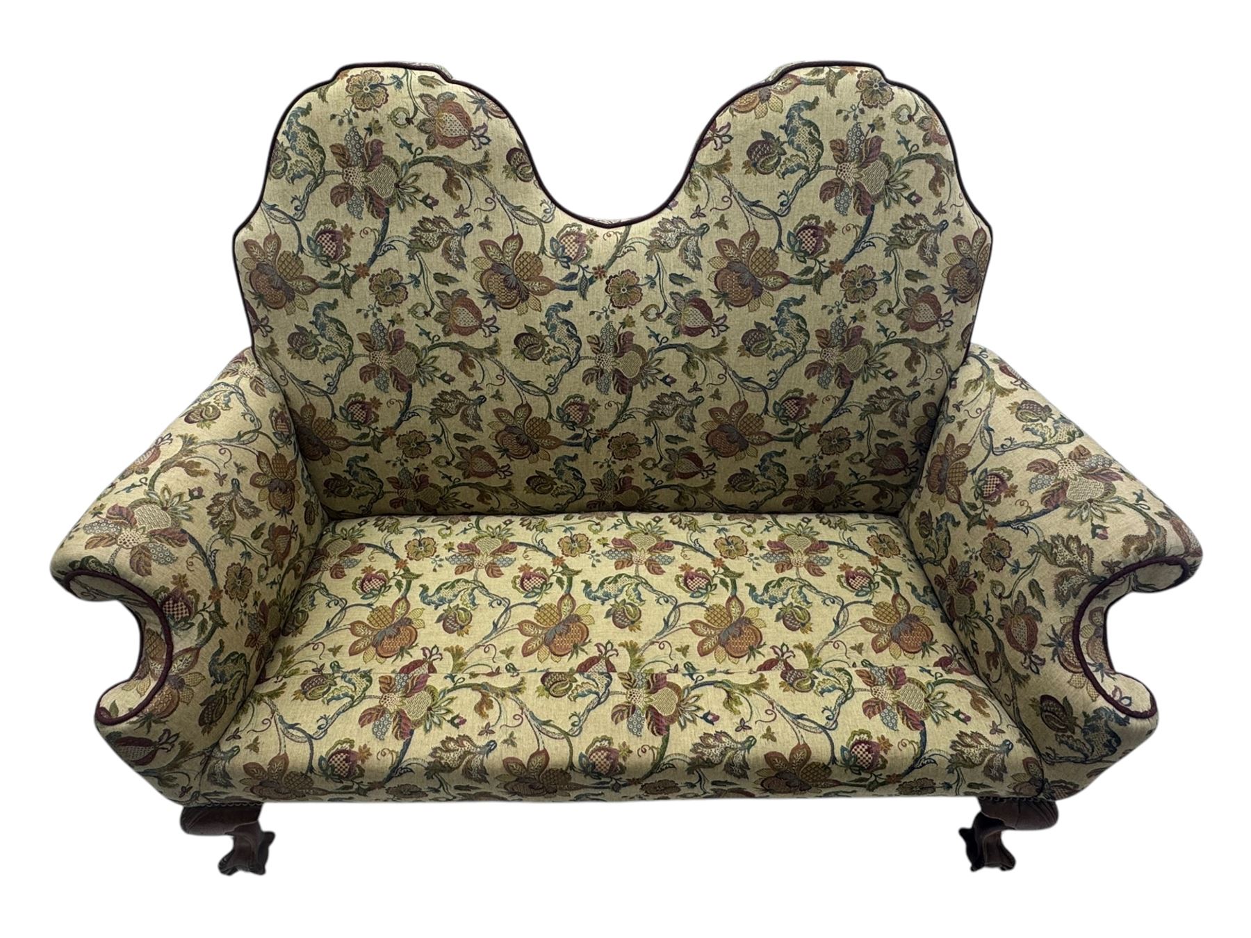 Mid-20th century William and Mary design two-seat sofa, upholstered in floral patterned fabric with contrasting piping, featuring camel-shaped back and scroll arms, on cabriole supports