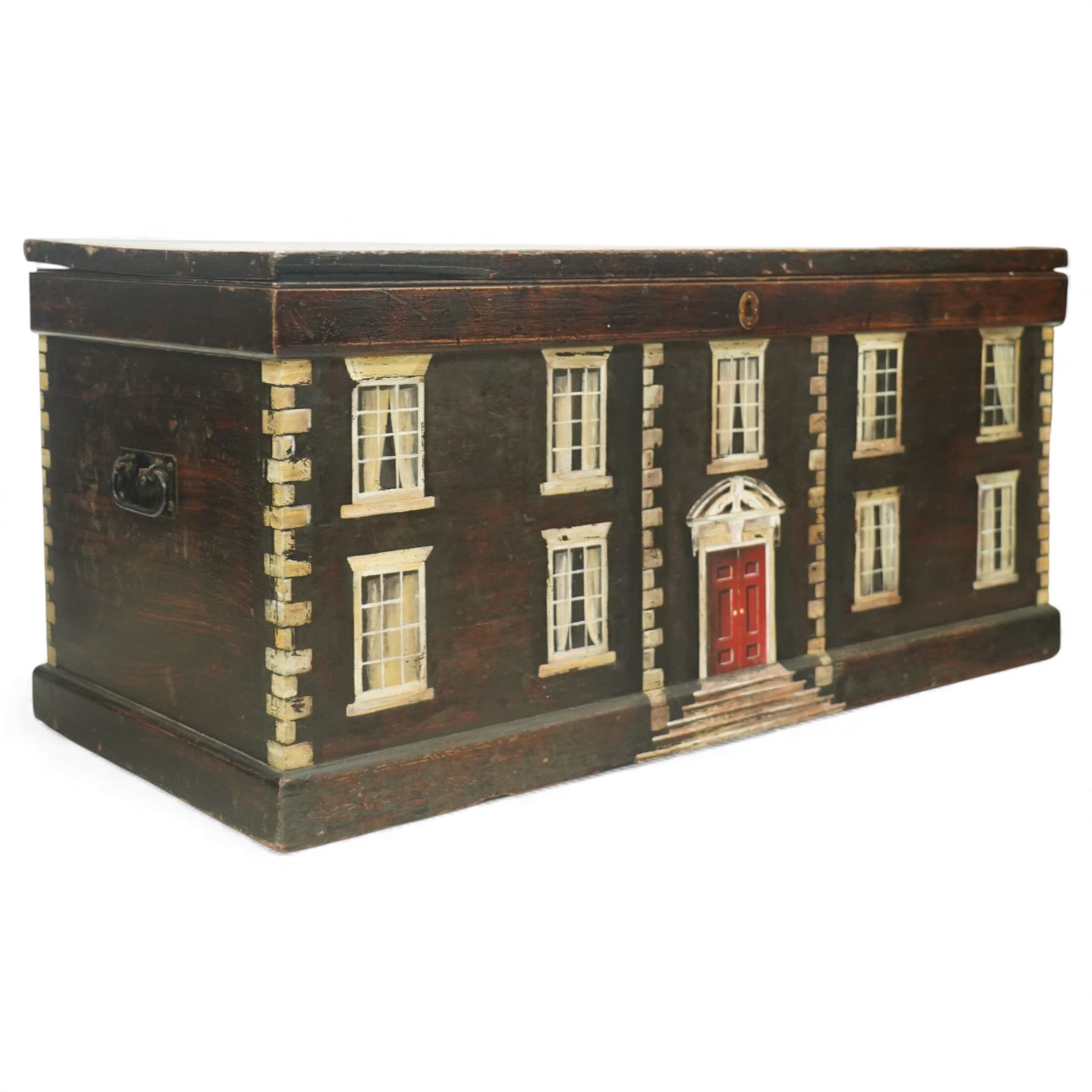 Georgian style painted wooden country house box, the rectangular hinged lid enclosing a plain interior, the exterior decorated as a symmetrical Georgian facade with sash windows, and central stepped and pedimented doorway, with moulded base and top edge