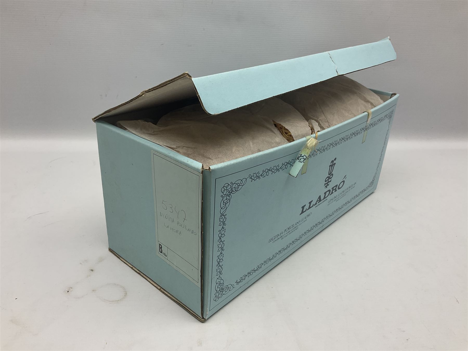 Lladro figure, Bedtime, modelled as a young girl reaching for her pet cat upon grandfather clock, sculpted by Vincente Martinez, with original box, no 5347, year issued 1986, year retired 1998, H28cm