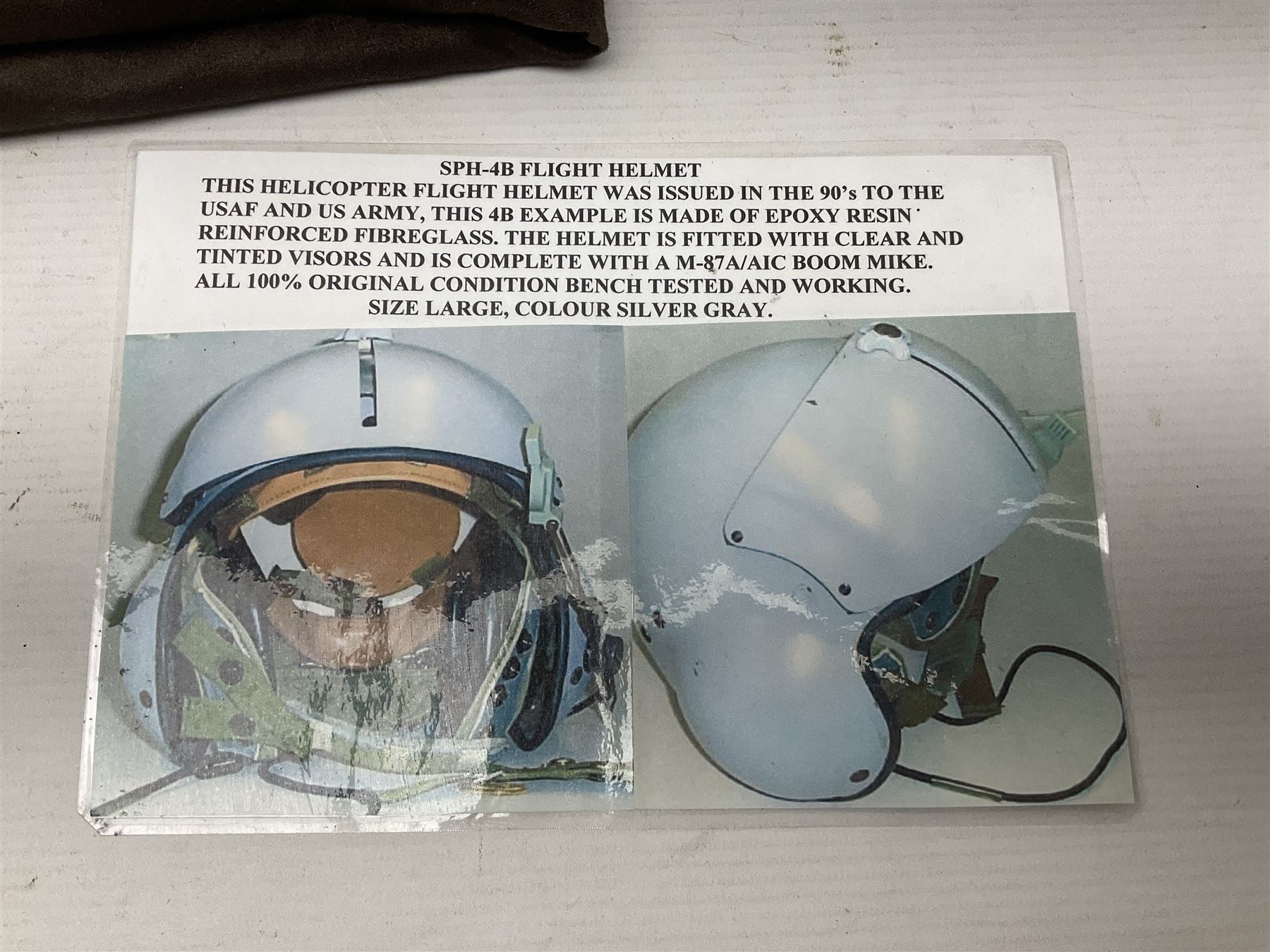 Silver grey SPH-4B Flight Helmet as used by helicopter pilots in the USAF and US Army in the 1990s; made of epoxy resin reinforced fibreglass; fitted with clear and tinted visors and complete with an M-87A/AIC boom mike; original condition and bench tested.