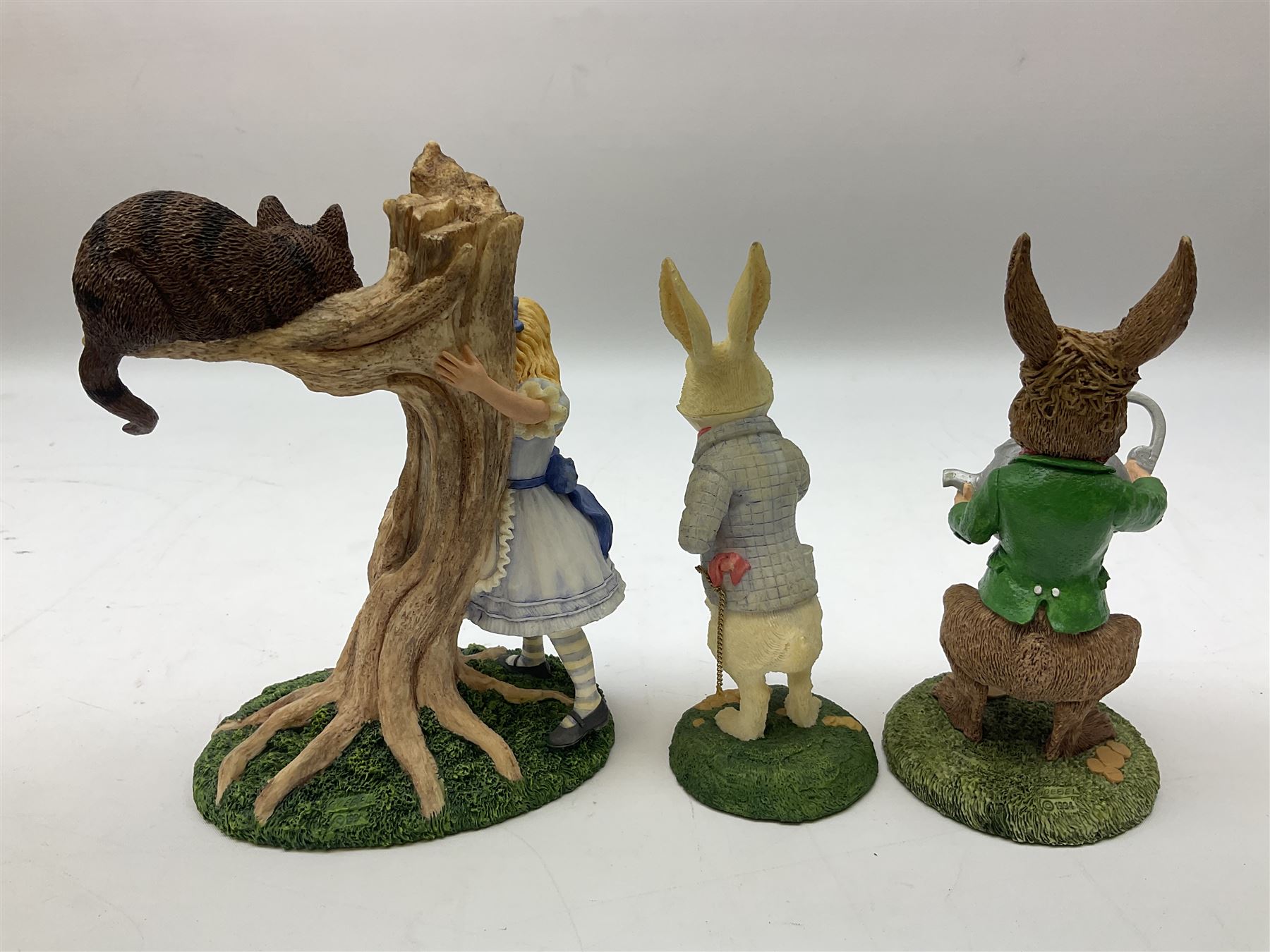 Goebel Alice in Wonderland figures, comprising Alice and Cat, White Rabbit, Queen of Hearts, March Hare, Tweedle Dee and the Mock Turtle, largest H18cm