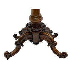 Victorian figured rosewood card table, fold-over swivel top with circular baize lining, moulded frieze with stylised flower head carving to corners, turned column with egg and dart decoration, on quadruple splayed c-scroll carved supports, with brass castors