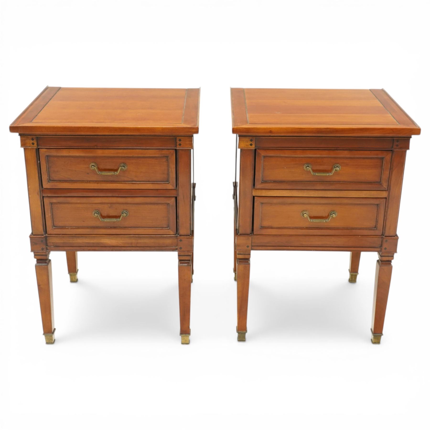 Willis & Gambier - pair of 'Directoire' cherry wood bedside tables, rectangular top with cock-beaded edge over two panelled facia drawers, raised on square turned and tapering supports on brass feet