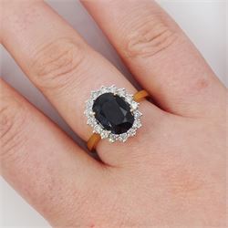 18ct gold sapphire and diamond cluster ring, single oval cut sapphire of approx 2.60 carat, surrounded by sixteen round brilliant cut diamonds, hallmarked, total diamond weight approx 0.45 carat