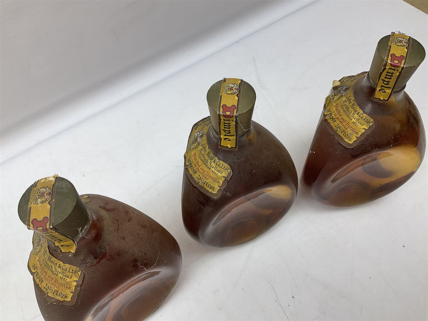 Four bottles of Haig's Dimple Old Blended Scotch whisky, all 26 2/3 Fl.OZs, 70 proof, one in original box and a bottle of East India 1961, Madeira, unknown contents and proof