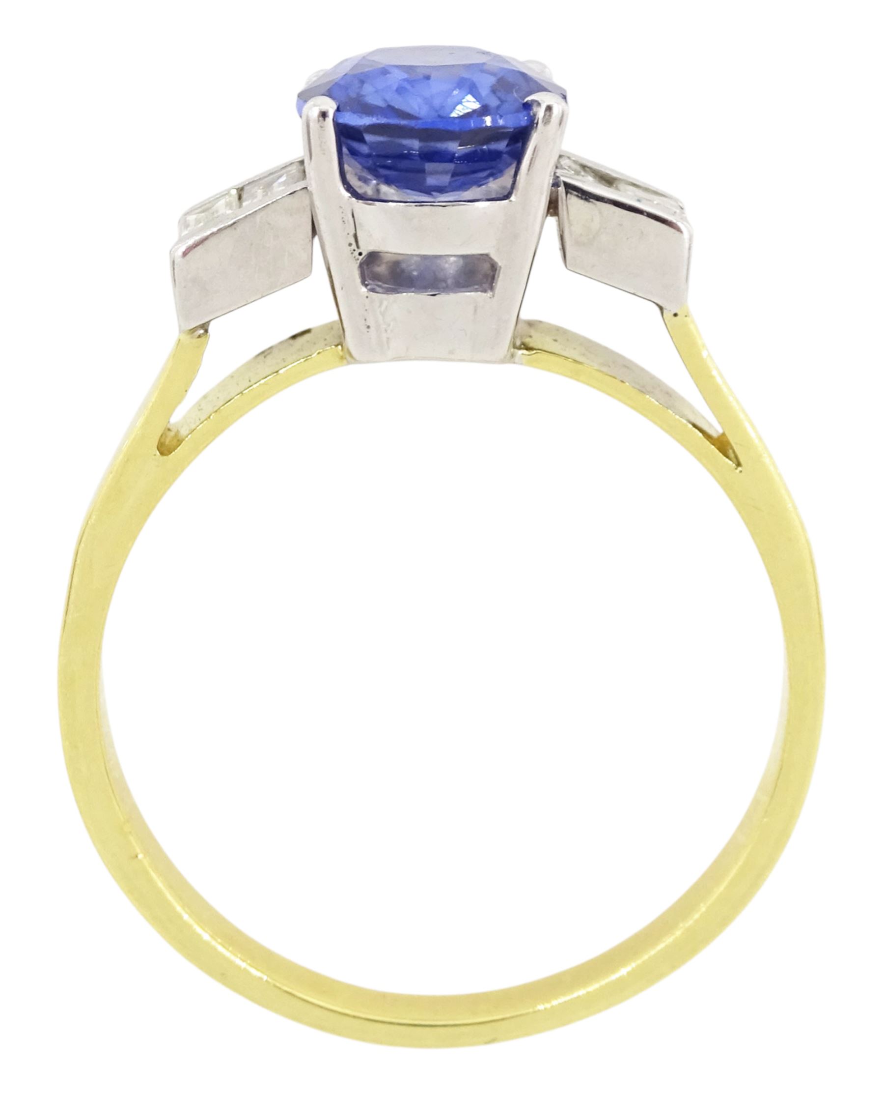 18ct gold tanzanite and diamond ring, single stone oval cut tanzanite of approx 1.75 carat, with two baguette cut diamonds set either side, stamped 750