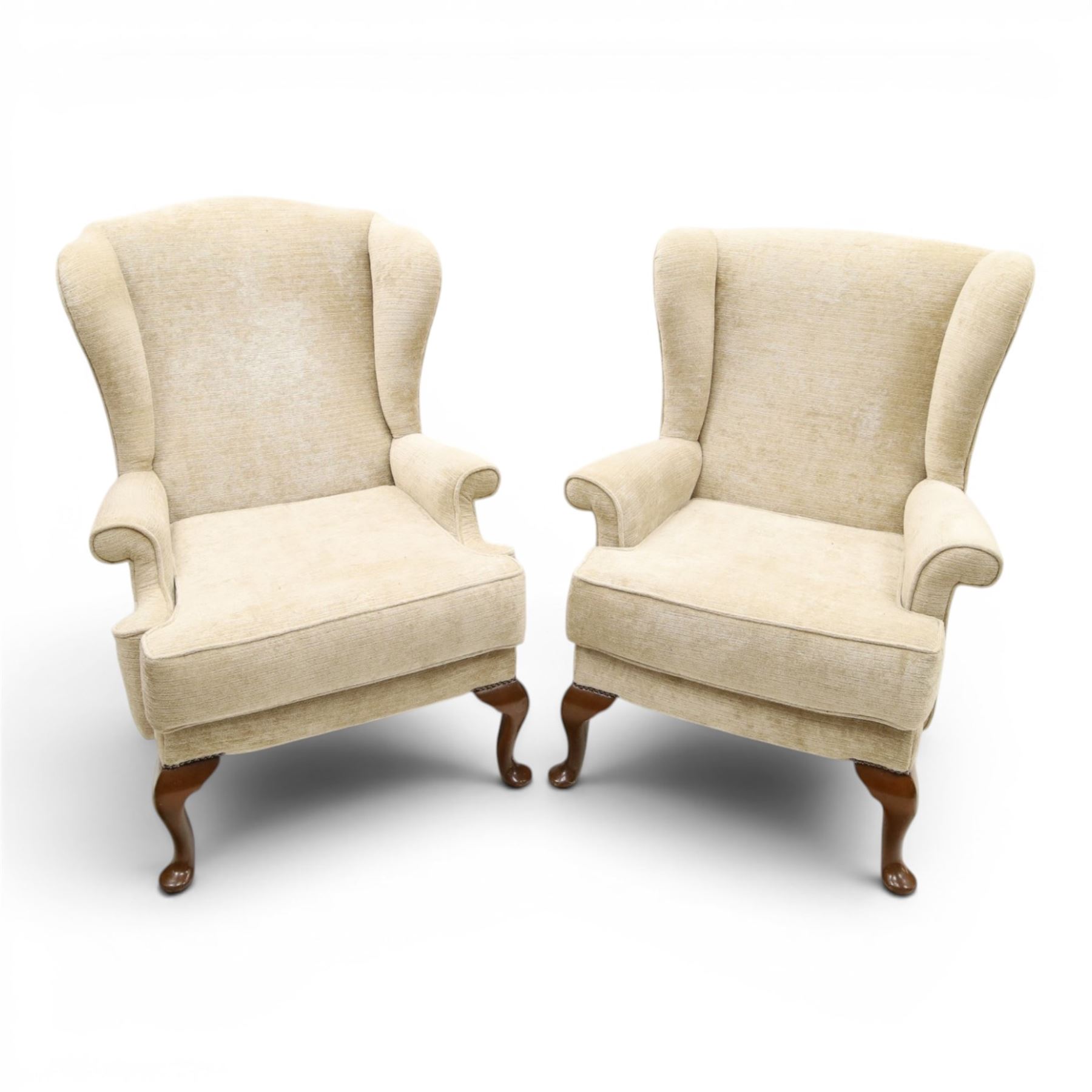 Parker Knoll - 'Hartley' lounge suite, comprising three wingback armchairs and two-seat settee, upholstered in cream fabric, shaped wing backs with scroll-over arms and loose seat cushions, on cabriole supports with pad feet wingbacks and settee

Armchairs: H 96cm, D 83cm, W 75cm