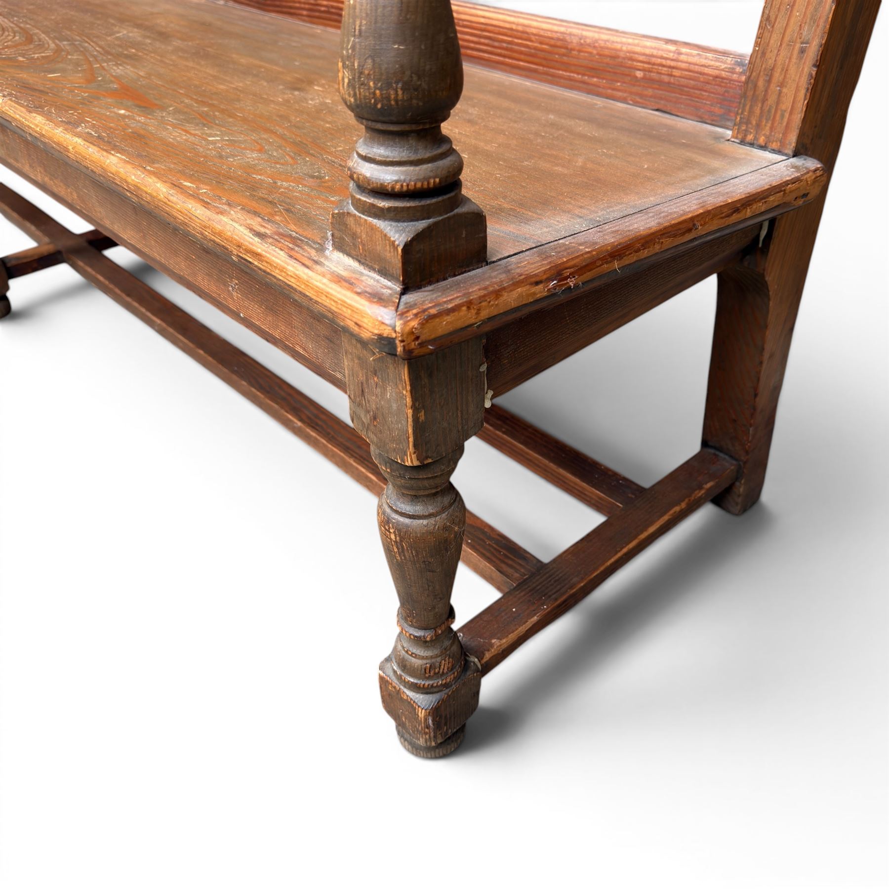 Early 20th century pine and oak bench seat, stained pine rail back frame with shaped oak arms