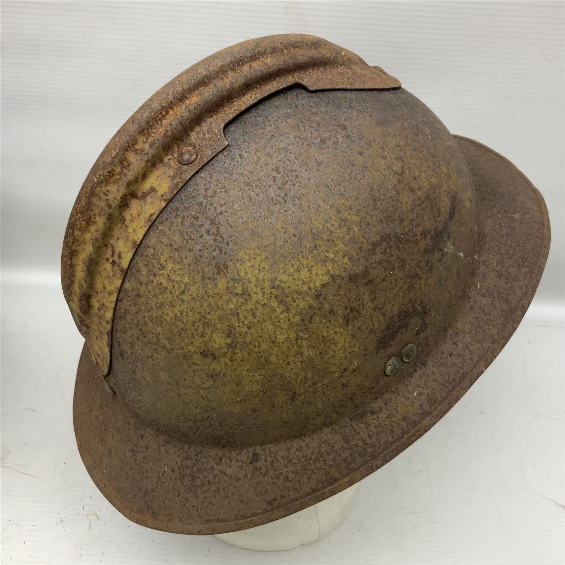 Three battlefield relic helmet shells - WWI German M16; WWI French Adrian; and WWII British (3)