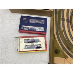 '00' gauge - table-top moulded plastic model railway layout with various rocky outcrops, tunnels, waterfall to lake, loops of Fleischmann track supplemented by Hornby track, bridges, kit built buildings and other accessories; together with Bachmann Class 150 2-car DMU Set and Hornby Northern Rail Class 142 2-car Set; both boxed; and small quantity of other rolling stock, three controllers etc  200 x 120cm
