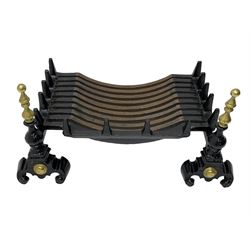 Black painted cast iron and brass fire basket, the andiron of finialed form with scroll feet
