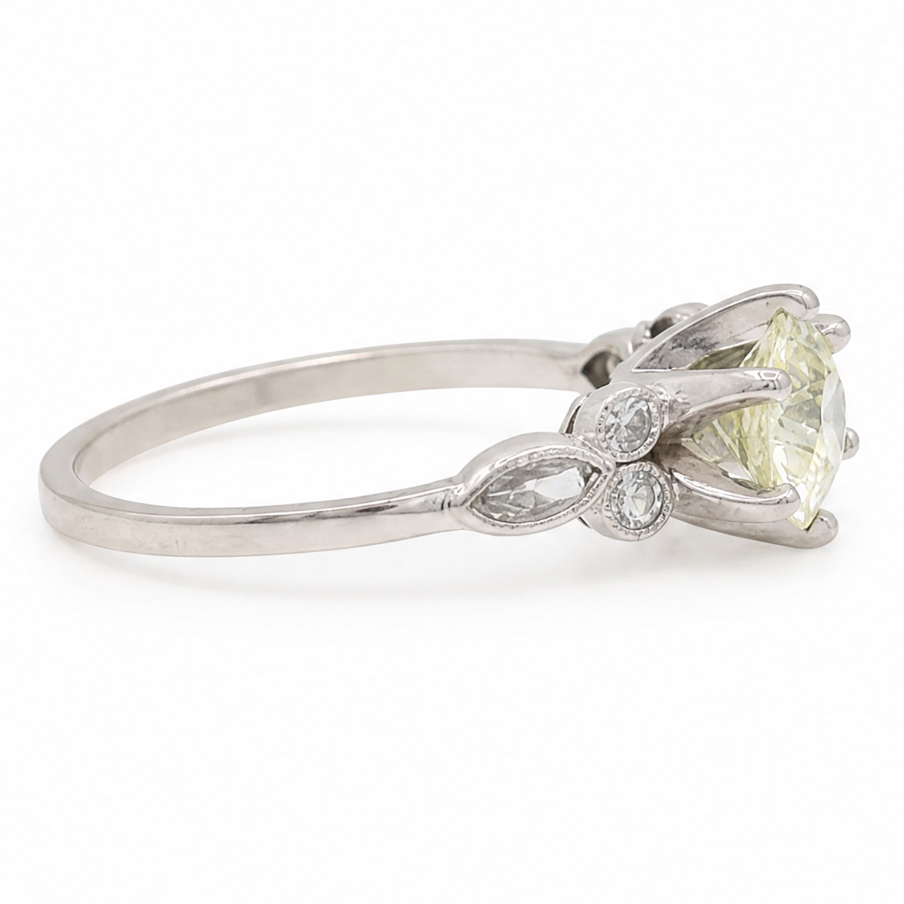 Platinum diamond ring, six claw set with a single old cut diamond of approx 1.35 carat, each shoulder milgrain set with two single cut diamonds and a marquise cut diamond, stamped Plat