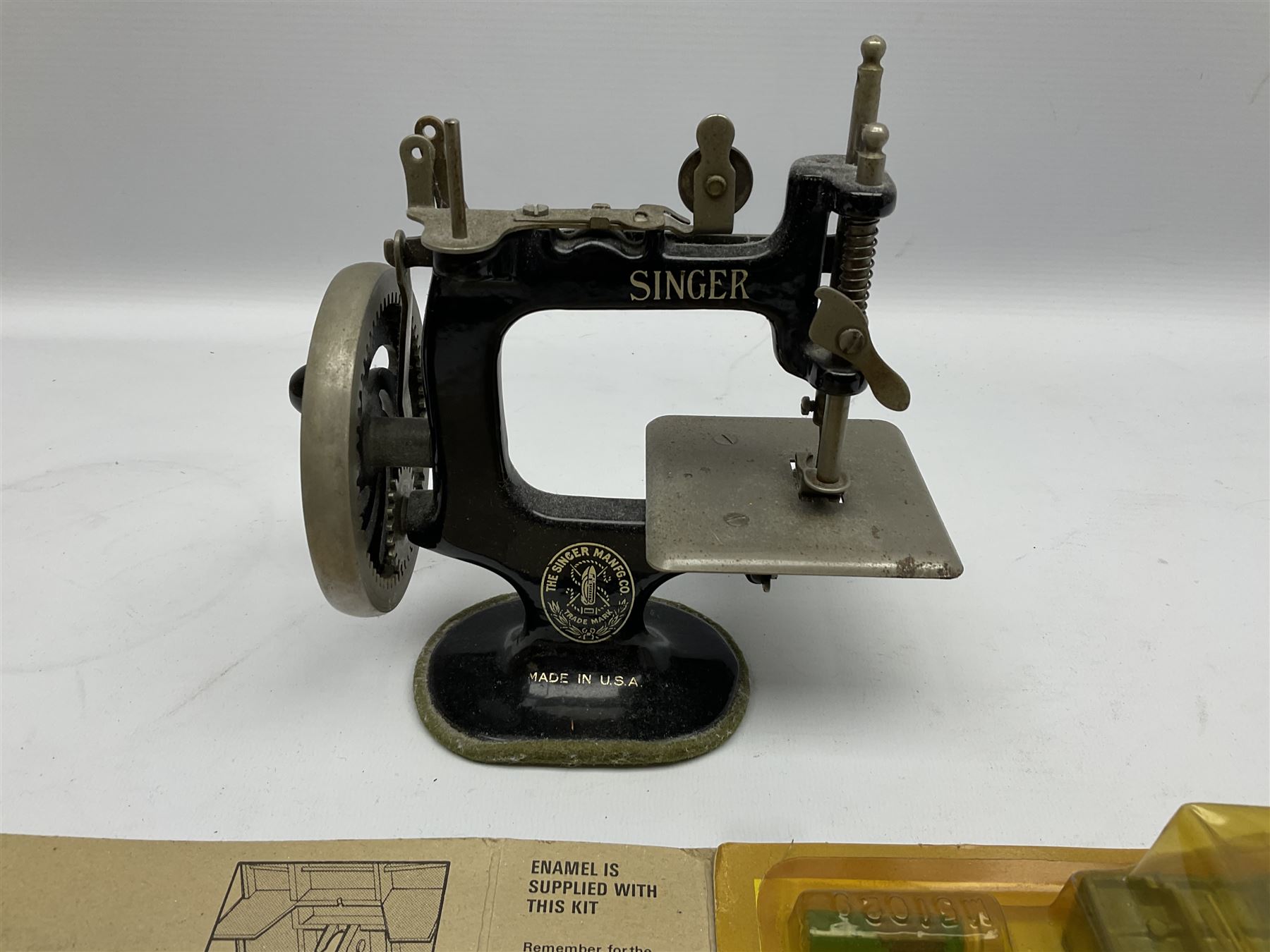 Dinky Kit No.1029 Ford D800 Tipper Truck in unopened original packaging; American Singer child's sewing machine; Spong's table mounting Bean Slicer No.632; and two wall mounting wooden die-cast model open display racks (5)