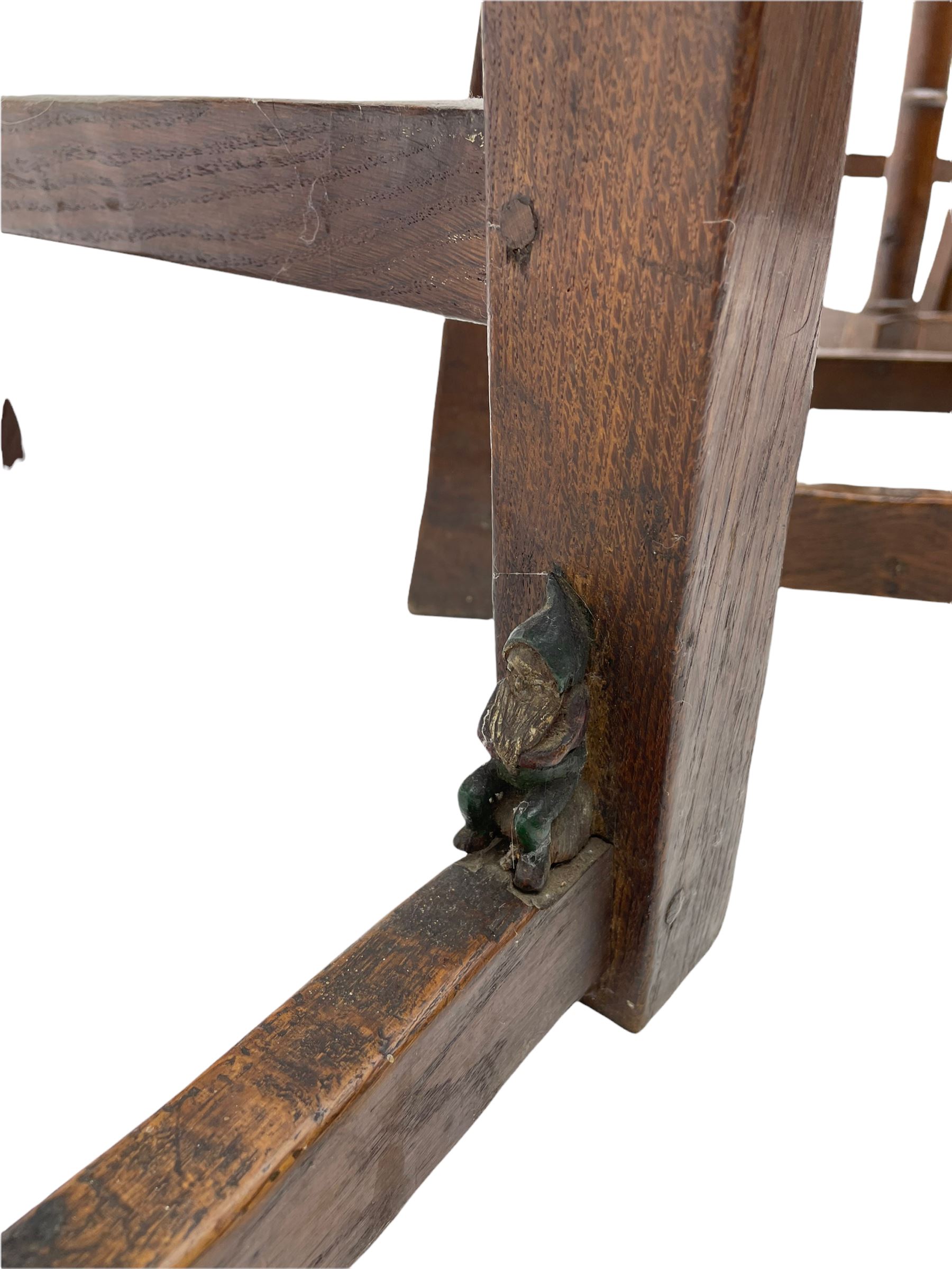 'Gnomeman' set of three oak dining chairs, panelled backs over curved seat rails with drop in rope rush seats, turned front supports with collar joined by plain stretchers, two with carved seated gnome figures, painted

Provenance - This collection of early 'Gnomeman' furniture comes to us directly from the Whittaker family. The pieces were made by the vendor's father Thomas Whittaker in the 1930/40s for his own use. During this time, he lived in York and made items for himself and friends. Whittaker adopted the gnome as a signature and trademark after his move to Littlebeck, Whitby.