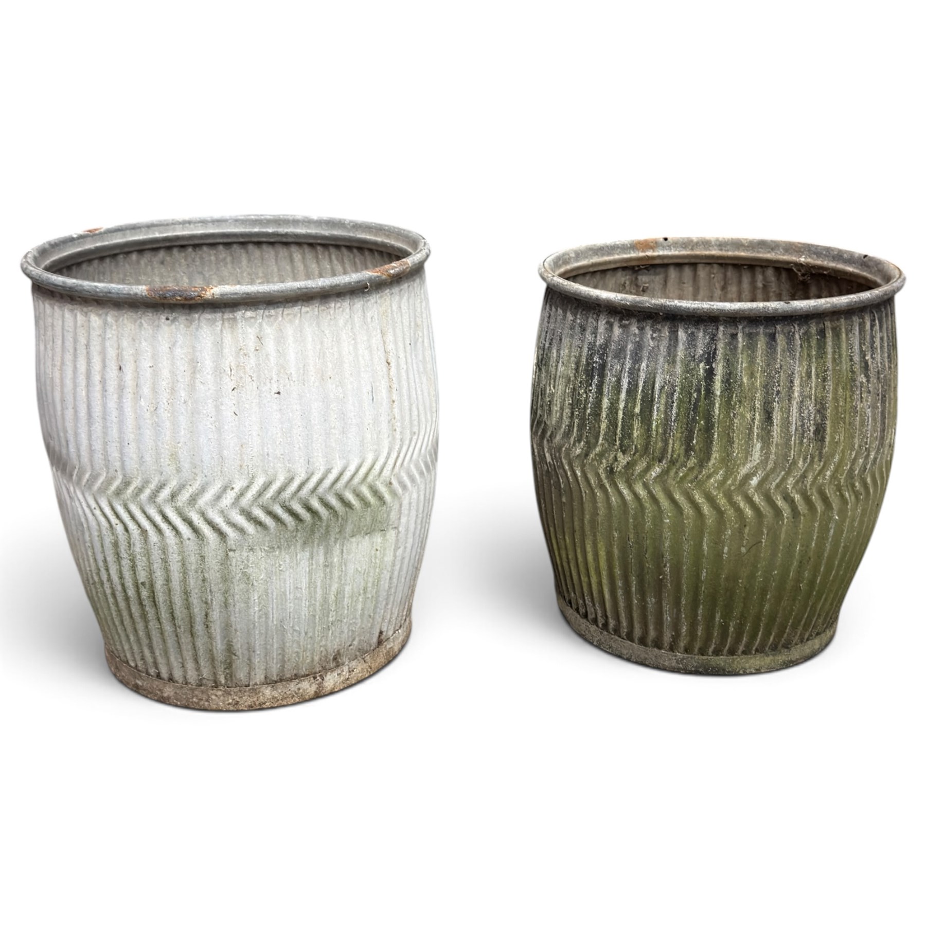 Two20th century galvanised metal dolly tubs, with rolled rims above corrugated bodies centred by chevron bands and circular bases, max W48cm H52cm)