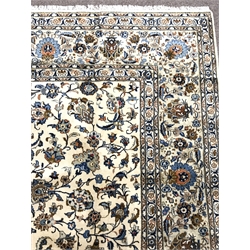 Large Kashan ivory ground rug, repeating border, blue trailing foliage, central medallion, 405cm x 306cm