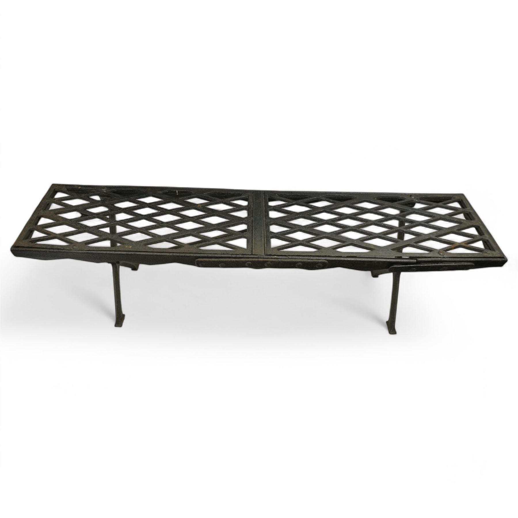 Two cast iron garden benches, rectangular seat with lozenge grate panels, on X-framed supports 