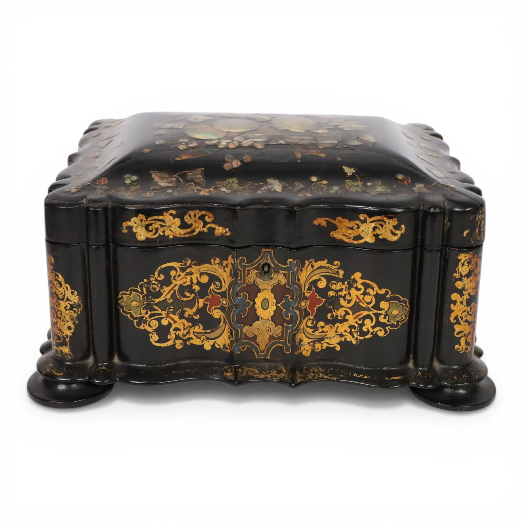 Victorian black lacquered papier-mâché sewing box, of rectangular form with shaped sides, the slightly domed top with inlaid mother of pearl and abalone decoration, the sides with gilt and polychrome painted scrollwork, the hinged cover opening to reveal a fitted interior with lift out tray, H14cm