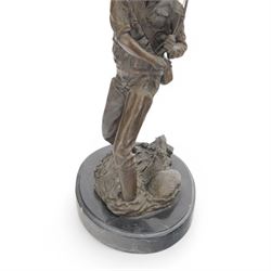 Bronzed figure of a fly fisherman, signed Milo, upon an oval marble base, H42.5cm