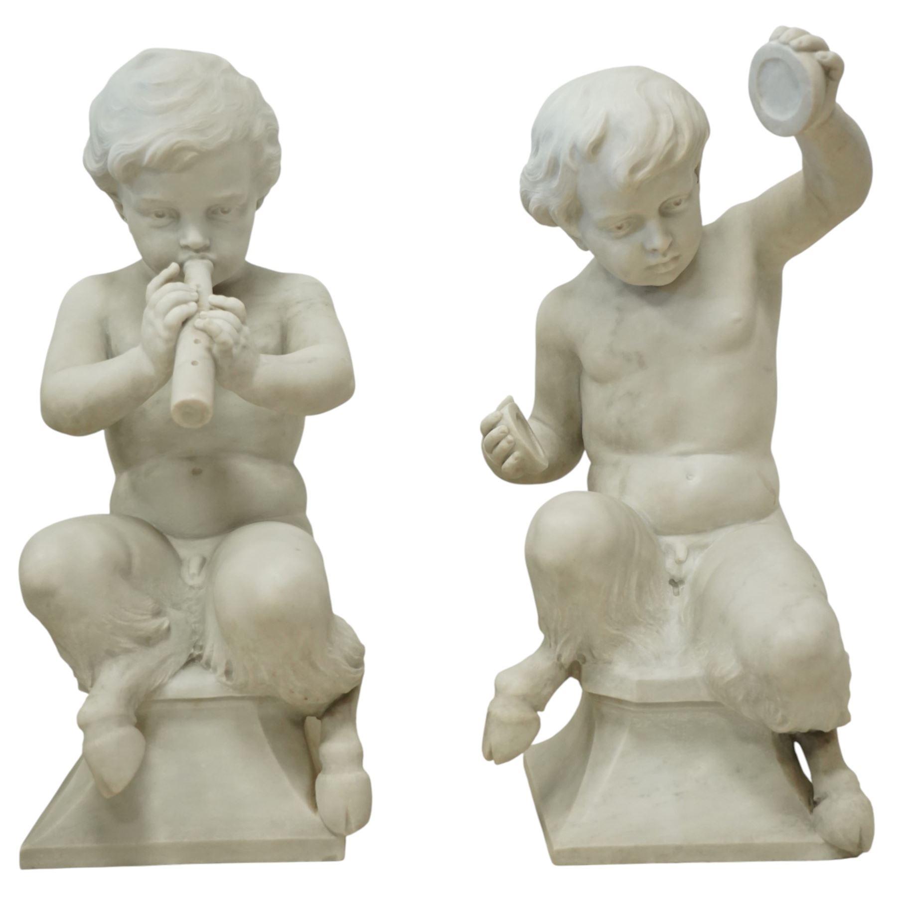 Follower of Claude Michel Clodion (French 1738-1814): The Putti-Faun Orchestra - set of four Italian carved white marble figures of child satyrs as musicians, each finely carved figure depicting a seated putto-faun with youthful features and small goat’s legs and cloven feet, variously playing rustic instruments: a syrinx (Panpipes), a flute, a tambourine and clappers - each raised on an integral waisted square plinth, Italian, circa 1900

Provenance: Kirkham Hall

Notes: Inspired by the rustic god Pan and his followers, these putti-fauns reflect the late-19th-century revival of classical themes popular with Grand Tour collectors; their instruments evoke the god Pan’s pastoral music, while the carving and  composition exemplify the appeal of bacchic subjects in the Italian neoclassical tradition