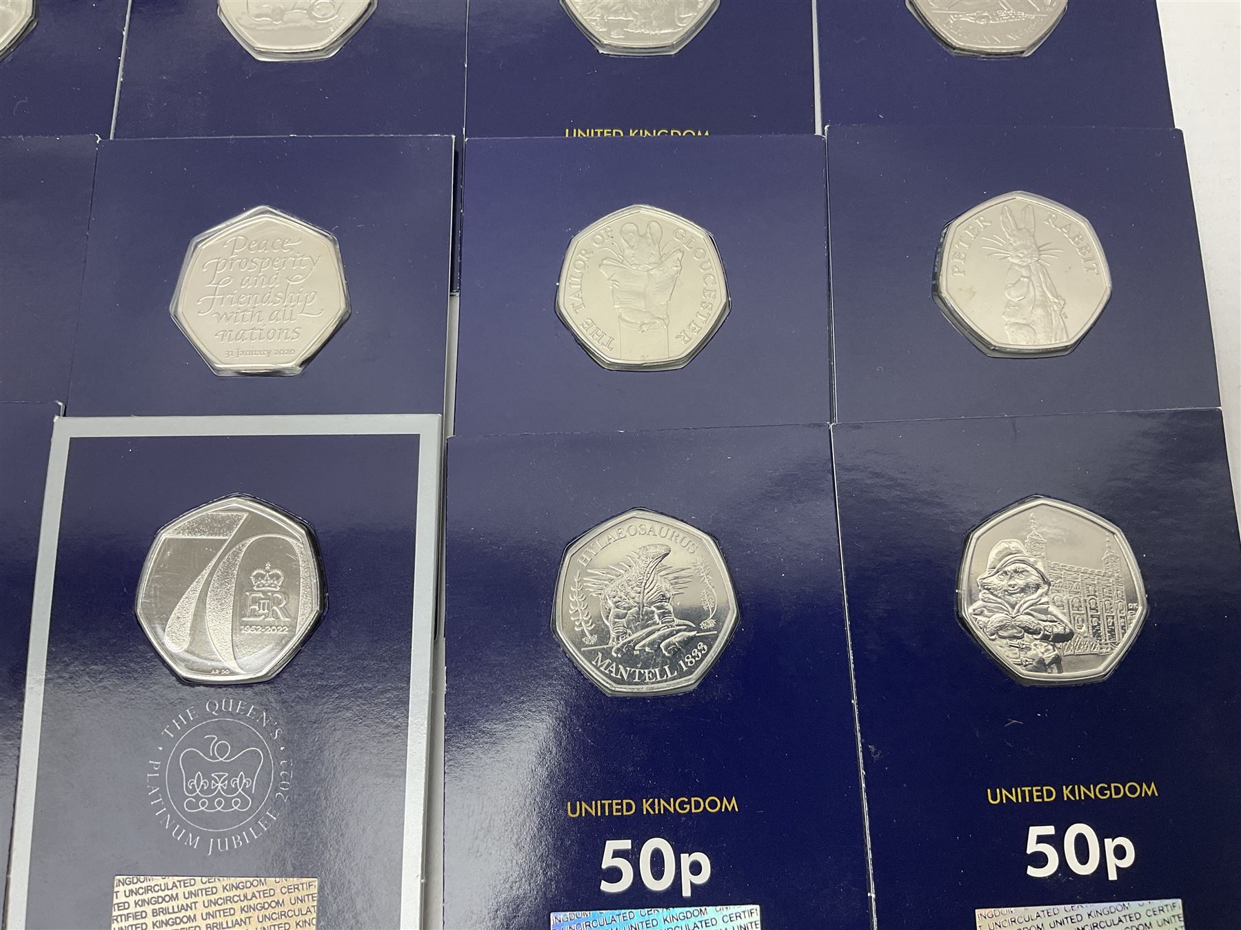 Mostly United Kingdom Queen Elizabeth II commemorative fifty pence coins, including 2019 'Gruffalo', 2020 'Iguanodon', 2022 'The Queen's Jubilee' etc, housed on cards, face value of UK coins approximately 20 GBP