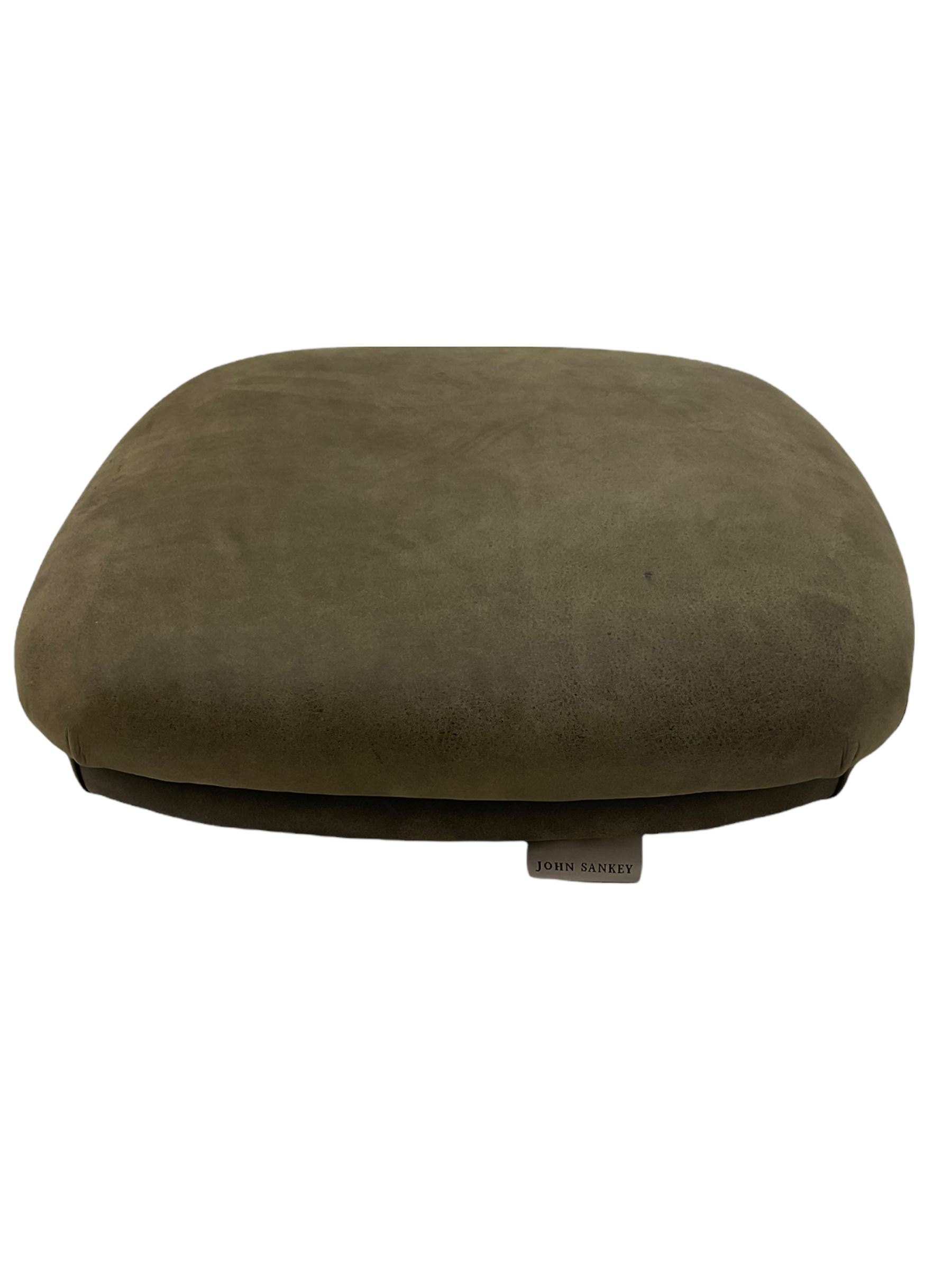 John Sankey - low armchair, buttoned back upholstered in tartan patterned fabric with contrasting grey leather, raised on turned and ebonised front feet with brass and ceramic castors, with matching foot stool