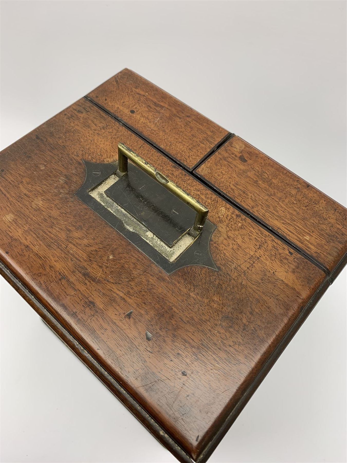 19th century mahogany travelling apothecary cabinet, with recessed brass carry handle to top, and two deep-section hinged doors to the front opening to reveal a fitted interior with clear glass bottles and two drawers, H27cm