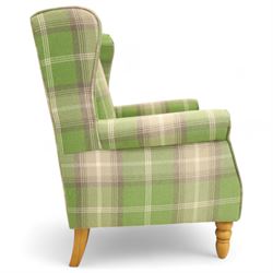 Contemporary green tartan upholstered wingback armchair, with scroll arms and loose seat cushion, raised on turned beech front supports with brass castors