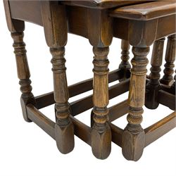 Solid oak nest of three tables, turned supports joined by stretchers