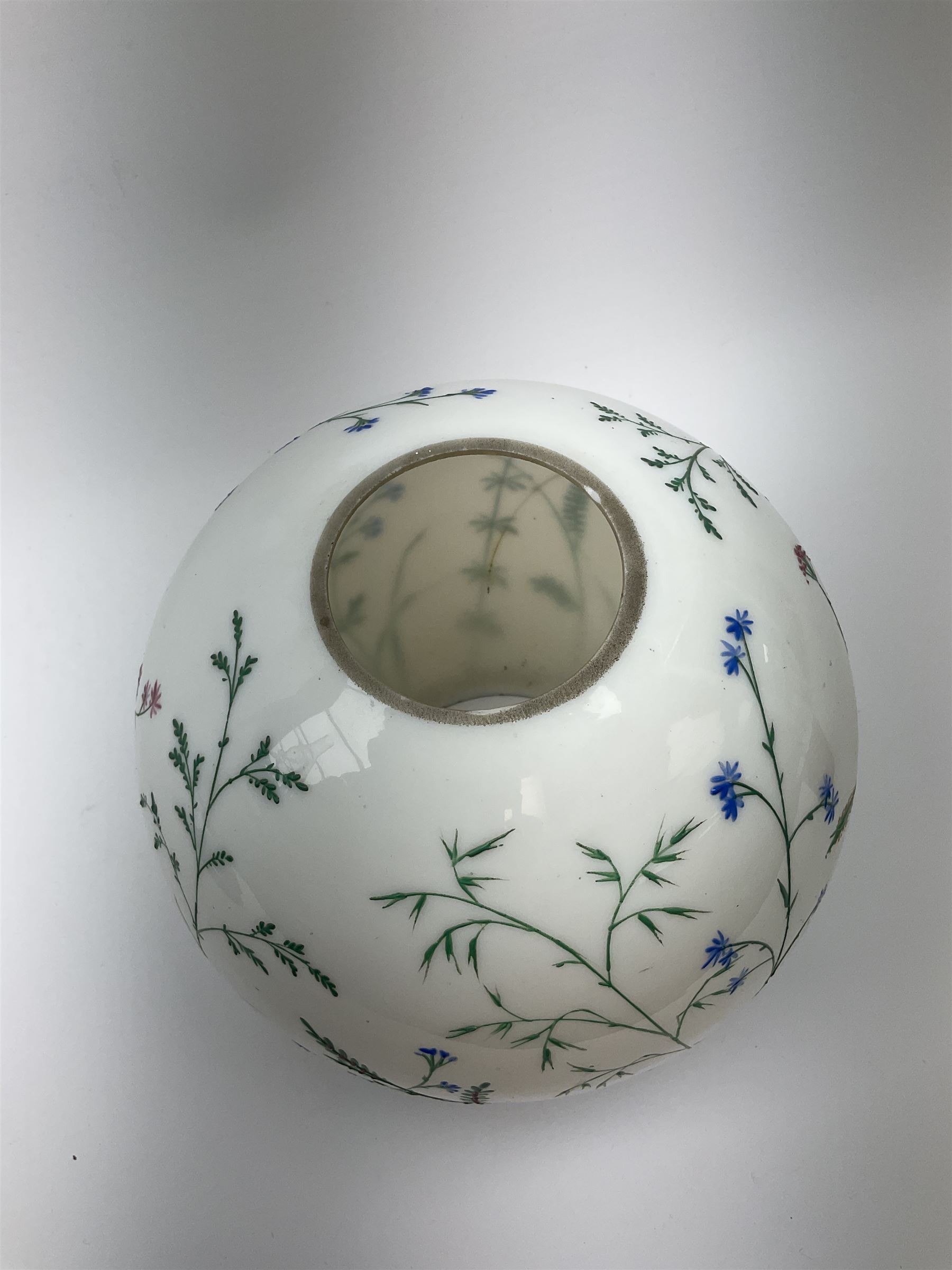 A Victorian oil lamp, with opaque glass reservoir hand painted with flowers beneath a Hinks burner and supporting a globular floral painted opaque glass shade and glass chimney, H47.5cm. 