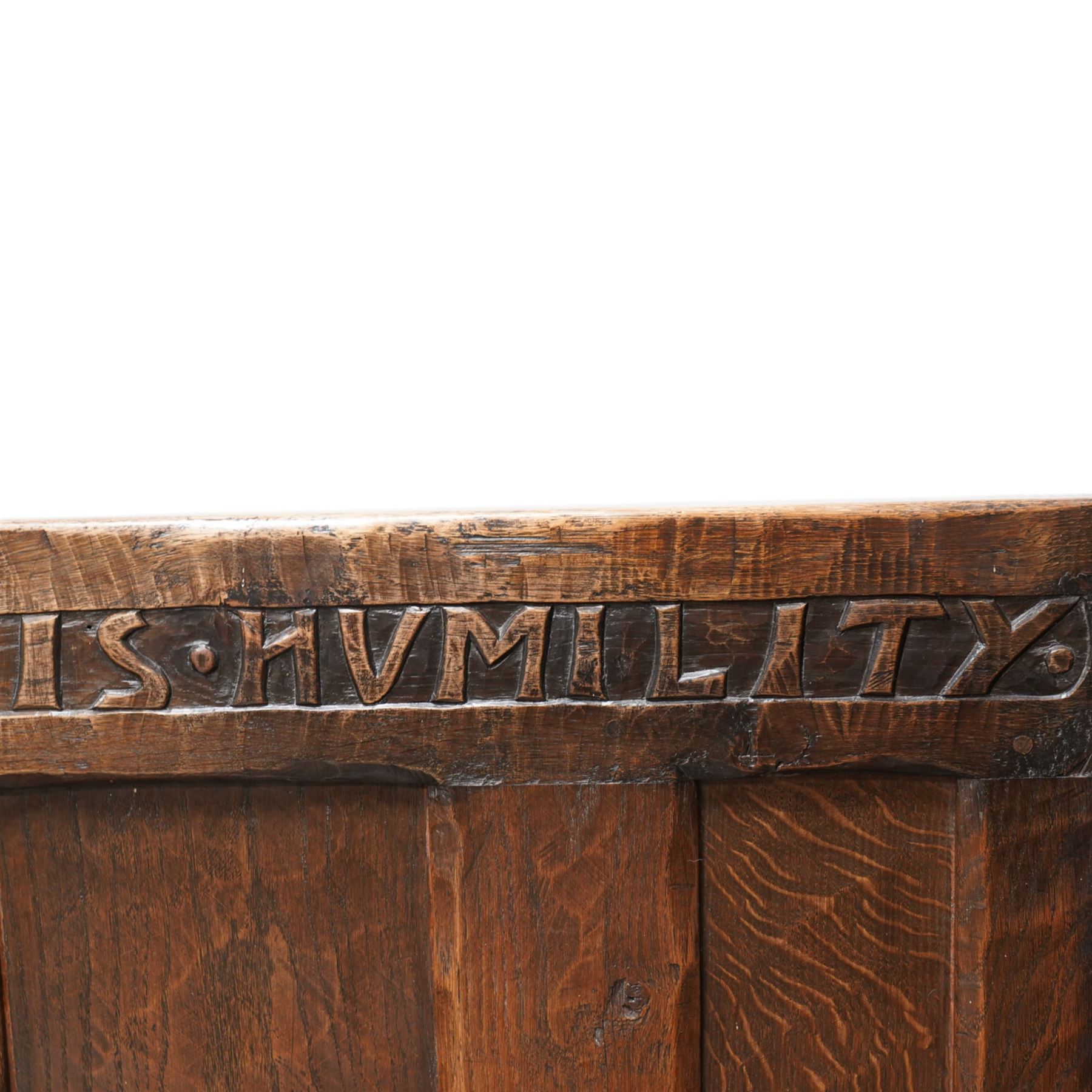 Mouseman - circa. 1920s adzed oak settle or bench, the cresting rail carved with inscription 'Before Honour is Humility', four panel back and plank seat on shaped end supports carved with grotesque masks terminals, carved with mouse signature, by Robert Thompson of Kilburn 

