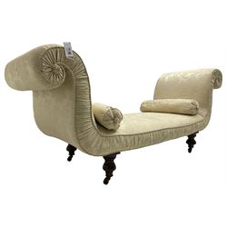 Victorian mahogany framed window seat day bed, the scrolled arms and seat upholstered in ivory foliate patterned damask fabric with matching ropetwist piping, raised on turned supports with castors