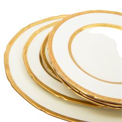 Royal Doulton 'The Balmoral' pattern dinner service for twelve place settings, comprising dinner plates, soup bowls and saucers, side plates, cake plates, three graduating meat platters, pair of tureens with covers and a pair of sauce boats with saucers, all with printed marks beneath