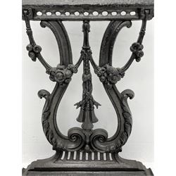 Victorian style cast iron umbrella and stick hall-stand, arched and scroll cast pediment over lyre shaped back, decorated with flower heads, moulded base with removable drip tray 