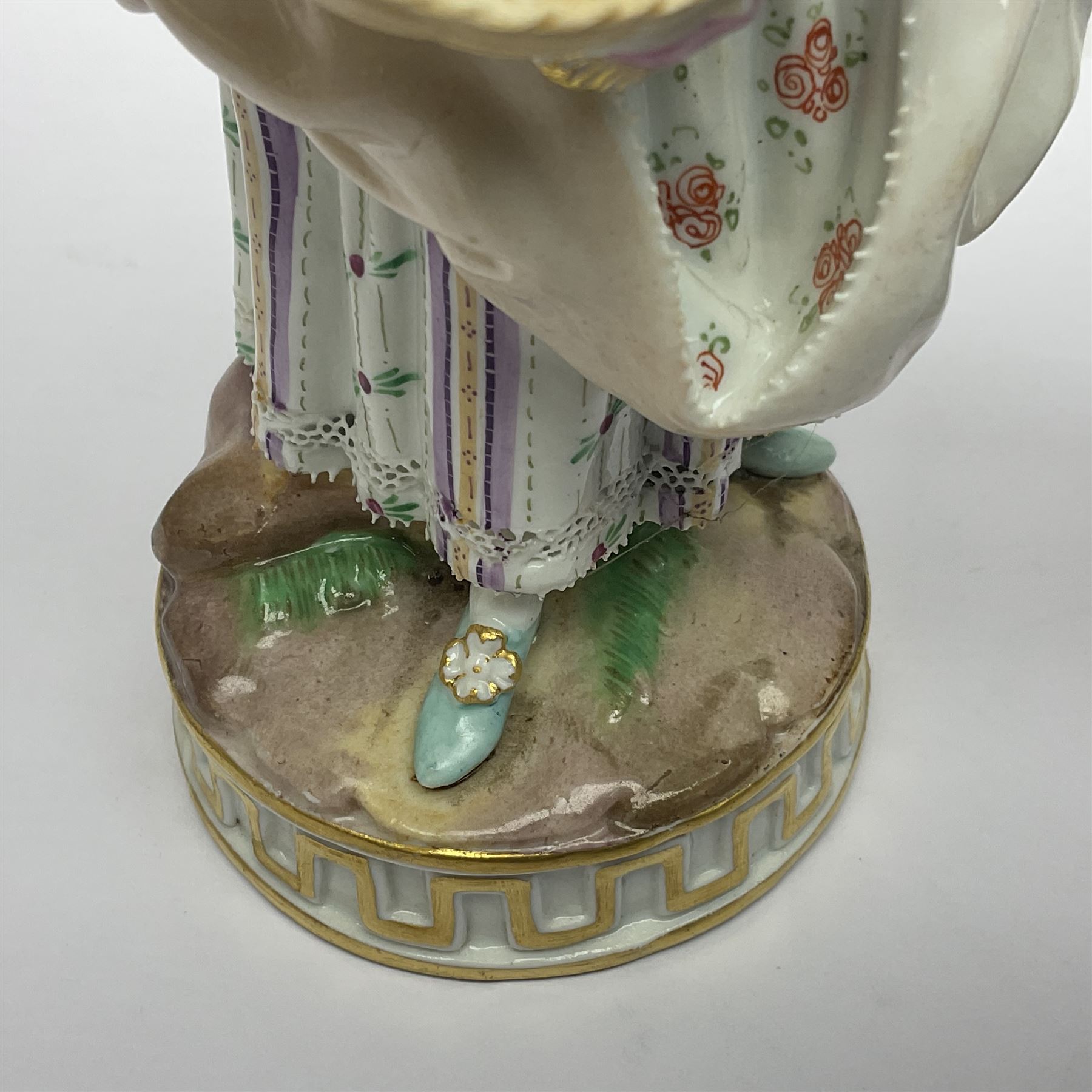 Pair of late 19th/early 20th Century Meissen figures, modelled as flower sellers, after the original by Michel Victor Acier, she holding basket of flowers, he holding flowers in his hat, each with underglaze cross swords mark beneath, tallest H16.5cm
