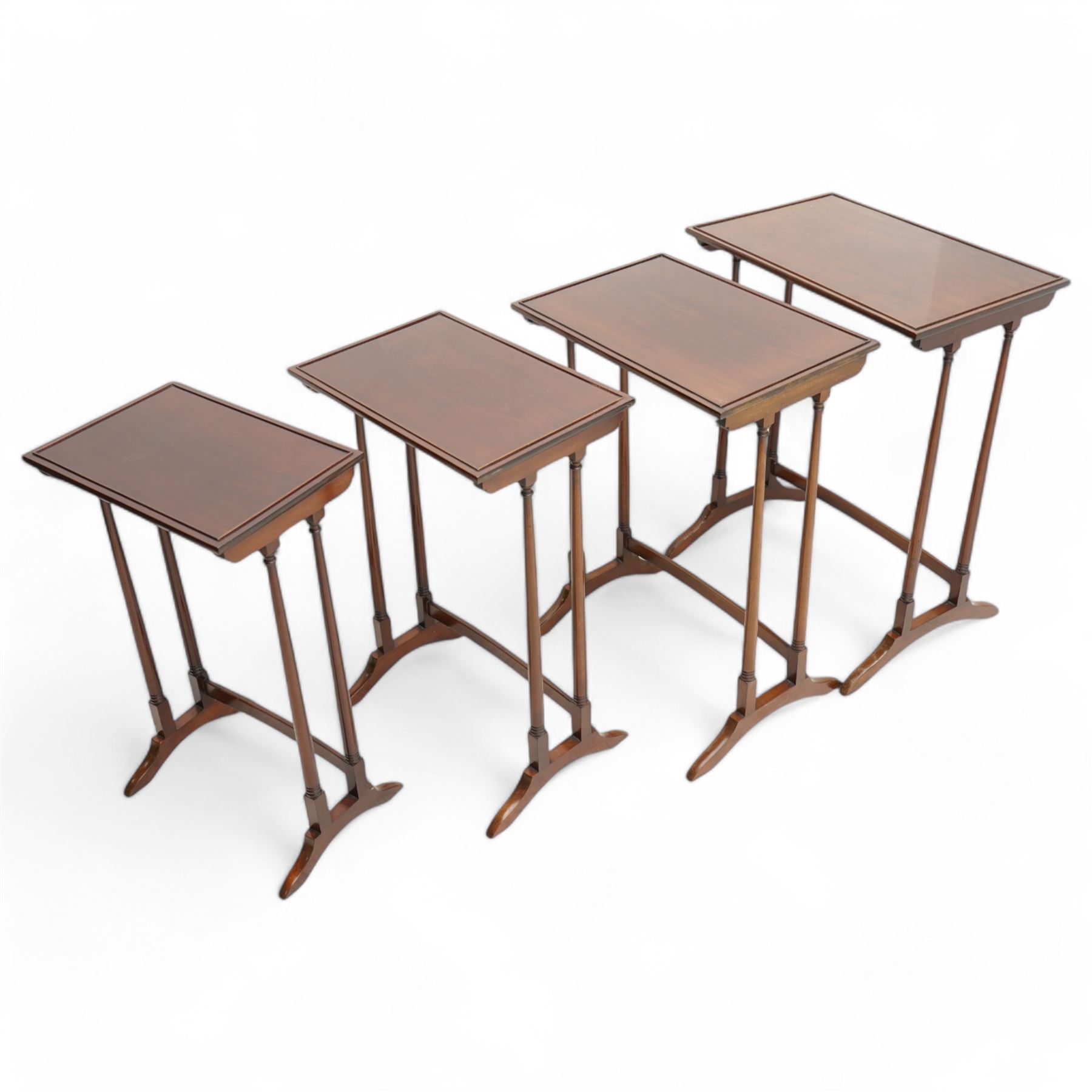 Early 20th century mahogany quartetto nest of four occasional tables, each with rectangular top with raised lip moulding, turned supports on splayed feet