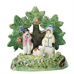 Pair of 19th century Staffordshire sheep, W13cm; together with a pearlware bocage group, H12cm (3)